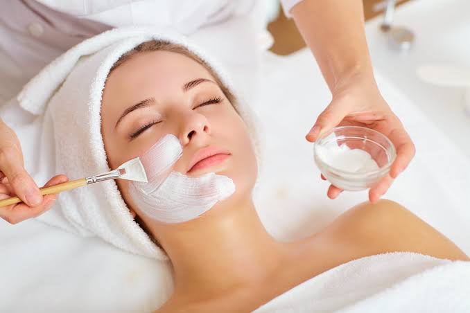 Client receiving a facial treatment that highlights the benefits of side of face waxing
