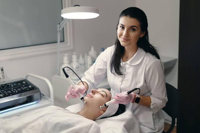 Experienced esthetician performing a facial treatment on a client
