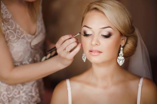 Lash artist applying bridal lash extensions during a pre-wedding appointment