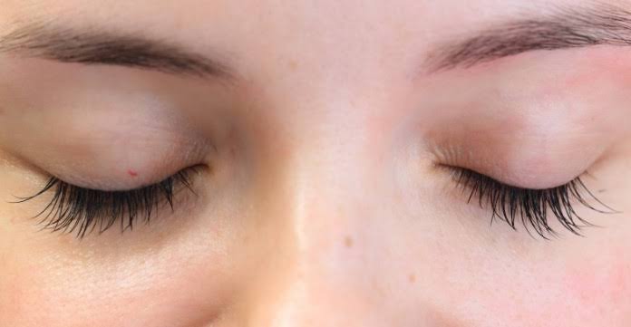 Close-up of natural-looking eyelash extensions on both eyes