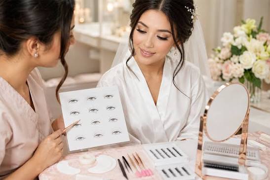Lash artist consulting with a bride using an eye shape chart to choose her bridal lash style